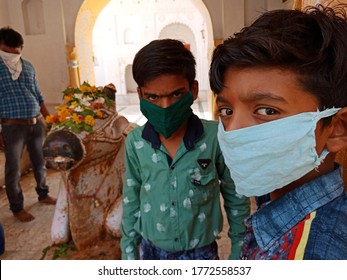 District Katni, Madhya Pradesh, India - July 08, 2020: Indian Boys Wearing Face Mask At Hindu Temple For Corona Virus Protection. 