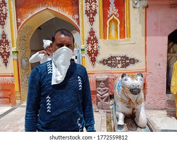 District Katni, Madhya Pradesh, India - July 08, 2020: An Indian Village Man Wearing Face Mask At Hindu Temple While Standing At Lord Premises For Corona Virus Protection. 