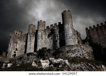 Disturbing scene with medieval castle at night with stormy sky