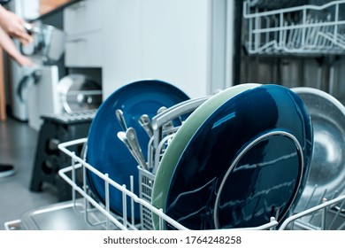 Diswasher Closeup With Woman Organizing Kitchen Objects