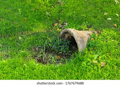 Ditch, conduit for transit of city fluids. Lawn, rural area. - Shutterstock ID 1767679688
