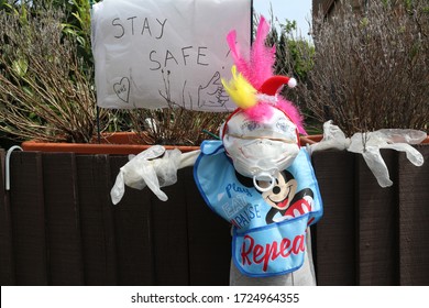 Ditchling, Lewes, UK - May 2020 Homemade Doll Represent Nhs Heroes In Front Of A House With Text Stay Safe To Cheer On Nhs Staff, Key, Care And Frontline Workers During Fight With Covid-19 Coronavirus