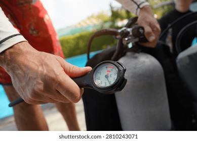 Dive instructor checking the diving equipment before training