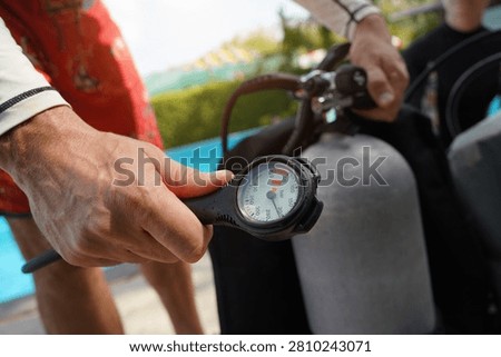 Dive instructor checking the diving equipment before training