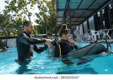 Dive instructor checking novice the diving equipment before diving