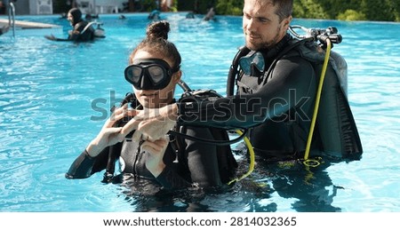 Dive instructor checking novice the diving equipment before diving