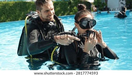 Dive instructor checking novice the diving equipment before diving