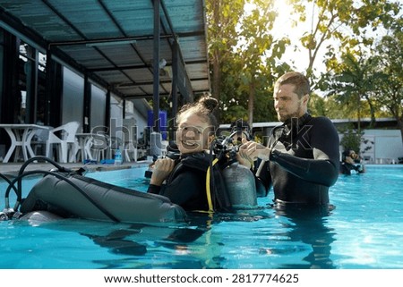Dive instructor checking novice the diving equipment before diving