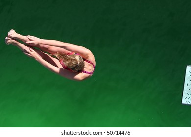 Diver Above Green Water With End Of Diving Board Visible