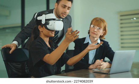 Diver business people working at office. Beautiful indian girl wearing virtual reality headset. Woman playing using VR goggles at office. - Powered by Shutterstock