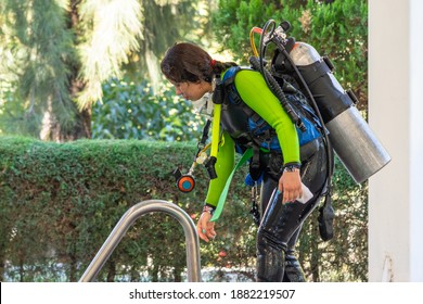 Diver Coming Out Of The Water By The Stairs Of The Pool After His Diving Class