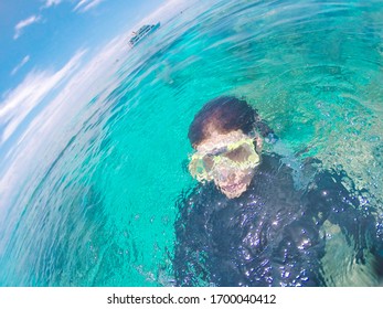 A Diver Emerging From The Ocean