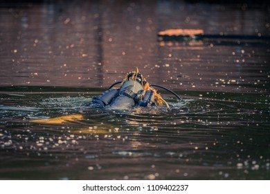 Diver Emerging From Under The Water