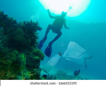 A Diver Finds Plastic Garbage Floating In The Ocean