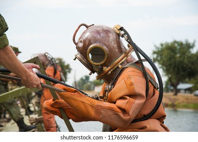 Diver Immerses In A Copper Old Vintage Deep Sea Diving Suit