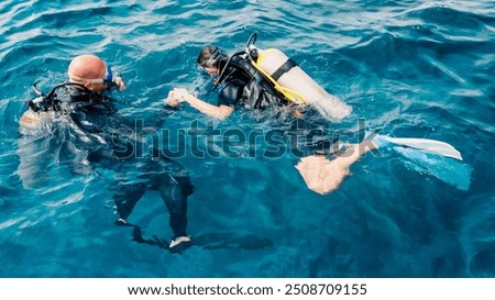 diver instructor teaches a beginner diver to dive in Egypt
