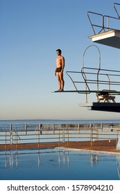 A Diver Standing On A Diving Board