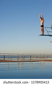 A Diver Standing On A Diving Board