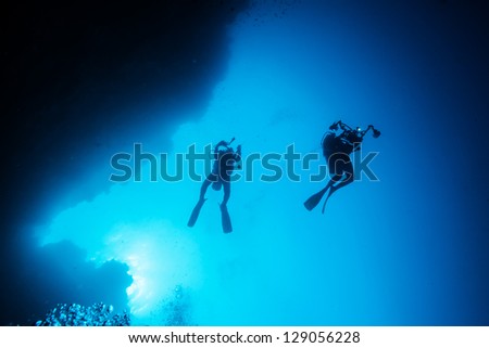 Similar – Two persons in their back with scuba diving equipment exploring the ocean floor.