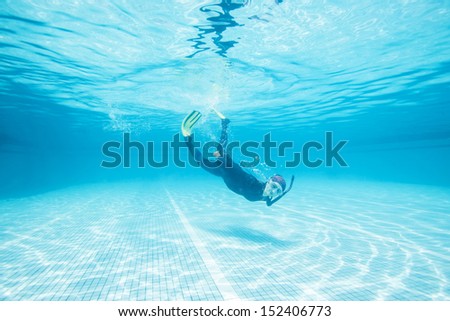 Similar – From below full body of unrecognizable active teen boy wearing yellow flippers snorkeling by coral reef in deep ocean with crystal clear waters at Menorca