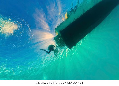 Divers Doing A Safety Stop Under The Dive Boat