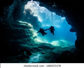 divers entering a cave system