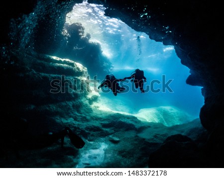divers entering a cave system