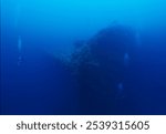 Divers exploring the wreck of the Japanese submarine tender, Heian Maru sunk during Operation Hailstone, Truk Lagoon.