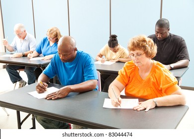 Diverse Adult Education Class Taking A Test In The Classroom.