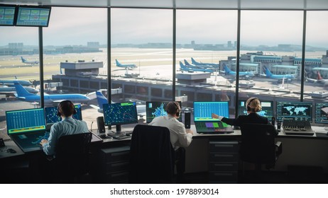Diverse Air Traffic Control Team Working in a Modern Airport Tower. Office Room is Full of Desktop Computer Displays with Navigation Screens, Airplane Departure and Arrival Data for Controllers. - Shutterstock ID 1978893014