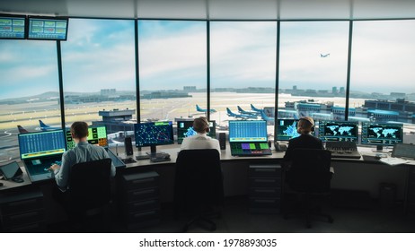 Diverse Air Traffic Control Team Working in a Modern Airport Tower. Office Room is Full of Desktop Computer Displays with Navigation Screens, Airplane Flight Radar Data for Controllers.