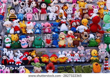A diverse array of crochet stuffed animals and dolls arranged on shelves at a market, showcasing bright colors and unique designs