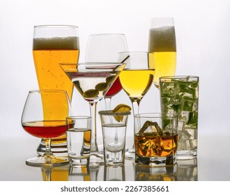 A diverse assortment of alcoholic beverages on a white background in a counter light