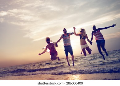 Diverse Beach Summer Friends Fun Jump Shot Concept - Powered by Shutterstock