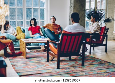 Diverse Best Friends Dressed In Casual Wear Communicating With Each Other Enjoying Leisure Time In Modern Apartment.Multicultural Young People Have Meeting To Play Game In Stylish Flat