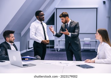 Diverse Black Employee And White Boss Arguing In Office, African Worker Disagreeing With Dismissal Firing Protecting Rights Or Behaving Rudely, Multiracial Conflict At Work And Racial Discrimination.