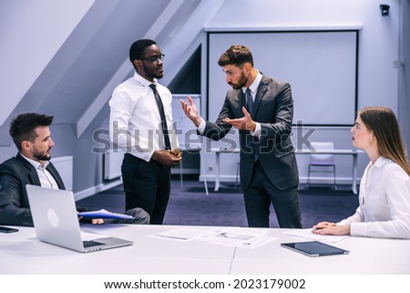 Diverse black employee and white boss arguing in office, african worker disagreeing with dismissal firing protecting rights or behaving rudely, multiracial conflict at work and racial discrimination.