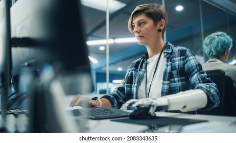 Diverse Body Positive Office: Portrait Of Motivated Woman With Disability Using Prosthetic Arm To Work On Computer. Brave Professional With Futuristic Body Powered Myoelectric Bionic Hand