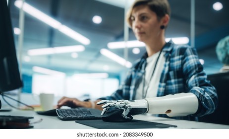 Diverse Body Positive Office: Portrait Of Motivated Woman With Disability Using Prosthetic Arm To Work On Computer. Professional With Futuristic Thought Controlled Myoelectric Bionic Hand