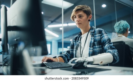 Diverse Body Positive Office: Portrait Of Motivated Woman With Disability Using Prosthetic Arm To Work On Computer. Brave Professional With Futuristic Thought Controlled Myoelectric Bionic Hand