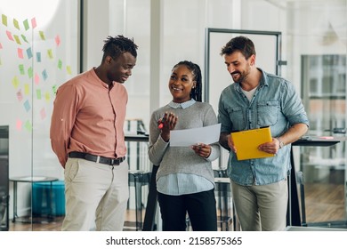 Diverse business colleagues discussing about documents used to accompany the company's monthly meeting, Multiracial business people discussing the company's annual sales report to the attendees. - Shutterstock ID 2158575365