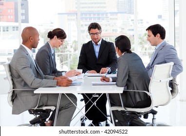 A Diverse Business Group Disscussing A Budget Plan In A Meeting