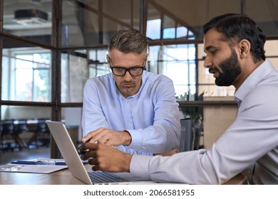 Diverse business people businessmen negotiating at boardroom meeting using working on laptop pc computer. Multiethnic executive team discussing financial partnership sitting at table in office. - Shutterstock ID 2066581955