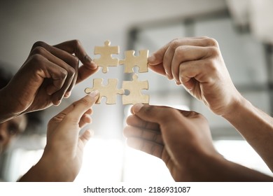 Diverse Business People Coming Together As A Team, Planning For The Future And Collaborating To Complete A Puzzle Closeup. Corporate Professionals In Unity Holding Up And Supporting Pieces