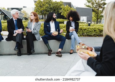 Diverse Business People Eating Takeaway Food At Lunch Break Outside The Office - Focus On Man With Leg Prosthesis