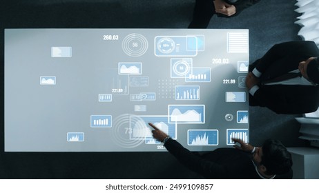 Diverse business people group discussing and brainstorming about marketing strategy with hologram of data analysis statistic or marketing investment graph while sitting at meeting room. Directorate. - Powered by Shutterstock