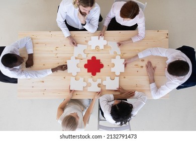 Diverse Business People Helping In Assembling Puzzle, Cooperation In Decision Making, Team Support In Solving Problems And Corporate Group Teamwork Concept, Connecting Pieces