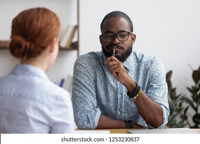 Diverse business people sitting in office, black ceo interviewing female for company position feel doubts that candidate meets requirements. Bad first impression and unsuccessful job interview concept