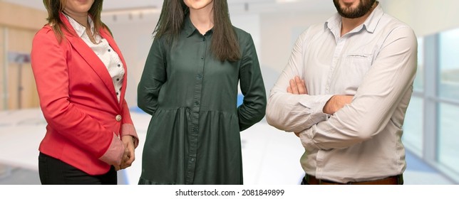 Diverse Business People Team Standing Together In Office, Group Portrait. Multiethnic International Young Professional Employees Company Staff Against Office Interior On Blurred Background