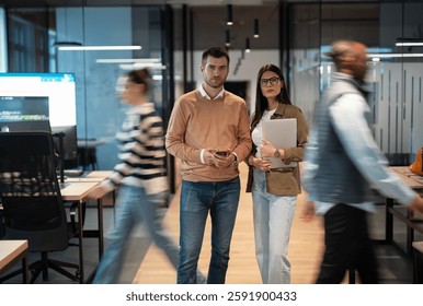 A diverse business team in a busy, modern office, collaborating on strategy and innovation. Executives, mentors, and professionals engage in discussions, digital transformation, and career development